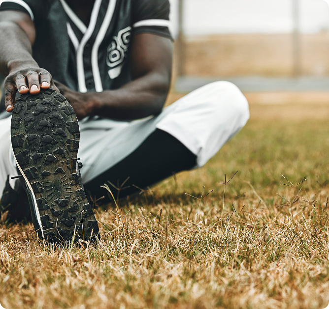 Athlete stretching on grass